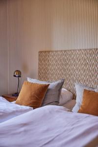 Un ou plusieurs lits dans un hébergement de l'établissement Rye115 Hotel