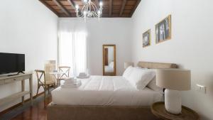 biała sypialnia z łóżkiem i telewizorem w obiekcie Italianway - Barberini Elegantia Apartments Roma w Rzymie
