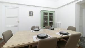 jadalnia z drewnianym stołem i krzesłami w obiekcie Italianway - Barberini Elegantia Apartments Roma w Rzymie