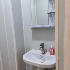 a bathroom with a white sink and a mirror at Renting a full apartment in the centre of Gyumri in Gyumri