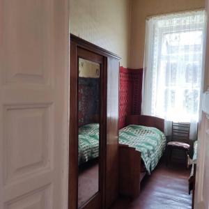 a room with a mirror and a bed and a window at Renting a full apartment in the centre of Gyumri in Gyumri