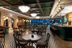 a restaurant with tables and chairs and a bar at Premier Inn Dubai Barsha Heights in Dubai