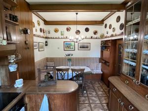 a kitchen with a table and a dining room at Hiša Kapitelj in Novo Mesto