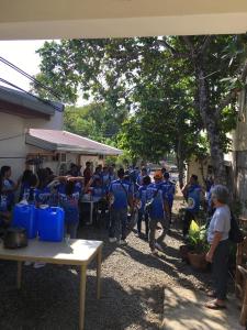 a group of people in blue uniforms standing in a yard at Czarina Transient House in Alaminos