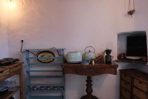 Habitación con escaleras, mesa y reloj en Salty Edge Holiday Home, en Serifos Chora