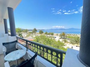 einen Balkon mit einem Tisch und Strandblick in der Unterkunft Galini Hotel in Pefki