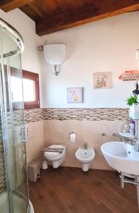 a bathroom with a sink and a toilet and a shower at Pambi House in Quartu SantʼElena