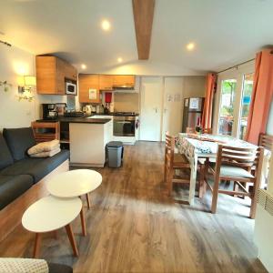 a kitchen and living room with a table and chairs at Mer et Liberté in Saint-Brevin-les-Pins