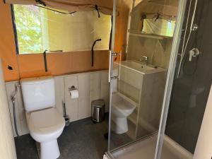 a small bathroom with a toilet and a shower at 'Glamping' Angelzelt am See mit Steg und Boot (Mecklenburger Seenplatte) in Blankensee