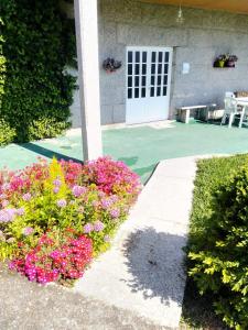 un jardín con flores frente a una casa en La Favorita, en Pontevedra