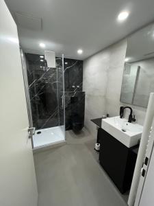 a white bathroom with a sink and a shower at Das kleine Landhotel in Dorsten