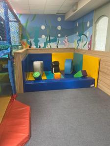 a childrens play room with a blue bench in a room at Hoburne Devon Bay beautiful 3 bedroom static caravan with decking in Paignton