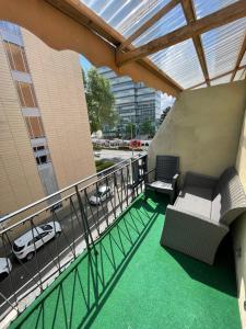 a balcony of a building with two chairs and a car at Liberty Hotel Cologne in Cologne