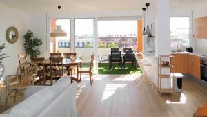 a living room with a couch and a table and chairs at Ocean Sun & Golf II in San Miguel de Abona
