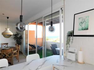 a kitchen and dining room with a table and chairs at Ocean Sun & Golf II in San Miguel de Abona