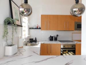 a kitchen with white counter tops and wooden cabinets at Ocean Sun & Golf II in San Miguel de Abona +37 photos