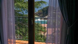 a room with a view of a beach from a window at CALA 51 - Villa with sea view in Blanes