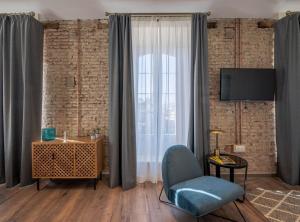 Televízia a/alebo spoločenská miestnosť v ubytovaní Home Art Apartments Málaga