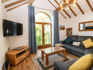 a living room with a couch and a table at Ty Gwennol in Beaumaris