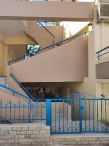 a set of stairs with blue railings in front of a building at Edem in Elafonisos