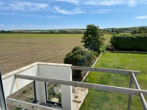 a view of a field from the balcony of a house at Cottars in Winfrith Newburgh