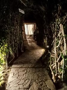 a stone path leading to a garage at night at B&B Il Sentiero in San Sperate