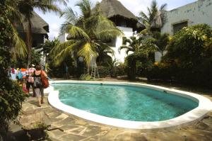 a swimming pool in the middle of a resort at Rischland Villas in Watamu
