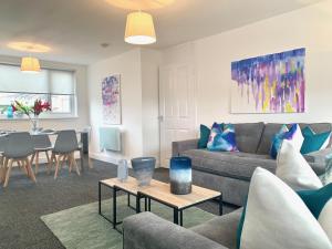 a living room with a couch and a table at Waverley in East Kilbride