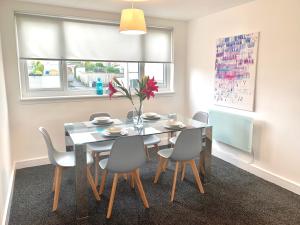a dining room with a table and chairs at Waverley in East Kilbride
