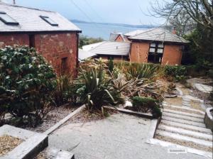 a house with a staircase in front of a house at The Coach House in Skelmorlie