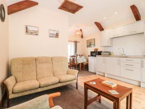 a living room with a couch and a table at The Old Lighthouse Cottage in Watchet
