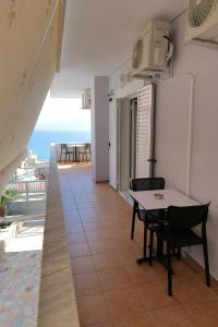 a room with a table and a view of the ocean at Kosta Apartments in Sarandë