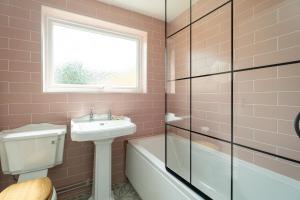 a bathroom with a sink and a toilet and a shower at Quay Cottage - Aldeburgh Coastal Cottages in Aldeburgh +20 photos