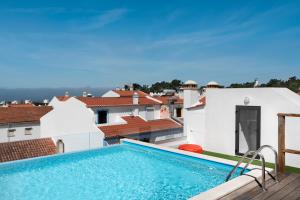 a swimming pool on the roof of a house at Lazy Days - Adults Only - Duna Parque Group in Vila Nova de Milfontes
