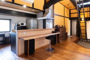 a kitchen with a counter and a bar in a room at TOKI NO YADO in Nakanogō