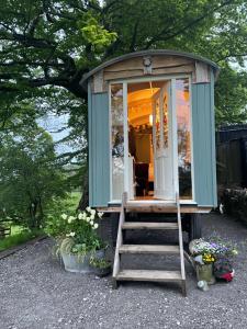 a tiny house with a staircase leading to it at Rhodes To Serenity - Waterfall Shepherds Hut in Cauldon