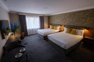 Postel nebo postele na pokoji v ubytování Talbot Hotel Midleton