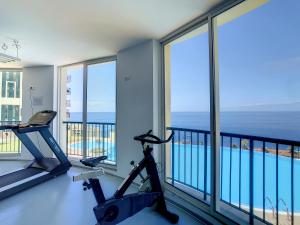 a room with a gym with a view of the ocean at Vila Formosa Top View by LovelyStay in Funchal