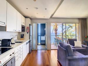 a kitchen and living room with a view of the ocean at Vila Formosa Top View by LovelyStay in Funchal