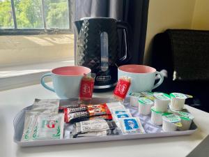 a tray of toothpaste and toothbrushes and cups on a table at Mirfield Monastery B&B in Mirfield