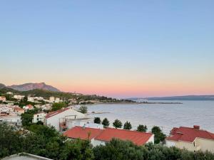 a view of a town and the ocean at sunset at Apartment Mandarina in Dugi Rat