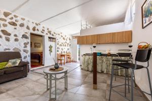 a kitchen and living room with a couch and a table at La Fortaleza - Casa La Fuentita in El Charco