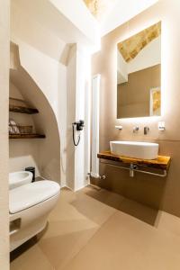 a bathroom with a white toilet and a sink at B&B A C-Caste in Monopoli