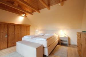 a bedroom with a bed and a table and a drawer at Ferienwohnung Dienst in Hagenburg