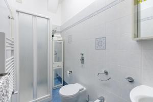 a white bathroom with a toilet and a shower at Appartamento Quadrifoglio - Affitti Brevi Italia in Milan