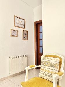 a white room with a chair and a radiator at Apartamento Turístico Casa Bari in Olivenza