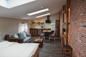 a room with a bed and a brick wall at Bietzhof in Großefehn 