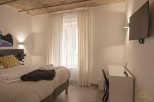 a white bedroom with a bed and a window at ALLA QUERCIA - CENTRO STORICO in Monterotondo