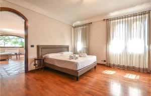 a bedroom with a bed and a living room at Cozy Home In Zafferana Etnea With Wifi in Zafferana Etnea