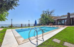 a swimming pool in a yard next to a house at Cozy Home In Zafferana Etnea With Wifi in Zafferana Etnea +35 photos